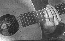 The bottleneck is worn on Kottke's little finger (photo by Gil Podolinsky).